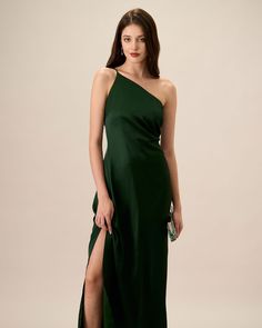 a woman in a green dress with one leg slited up and the other side split open