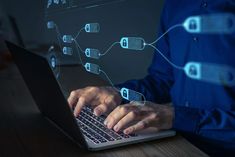 a man is typing on his laptop while connected to various devices and symbols are floating above him