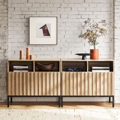 a living room with white brick walls and wooden furniture