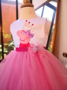 a peppa pig dress on display in front of a window