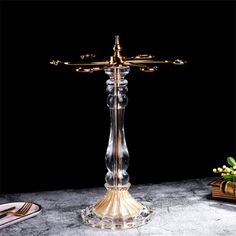 a candle holder on a table with other items in front of it and a black background