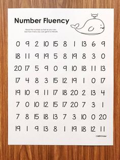 a printable number flueny sheet on a wooden surface with numbers in it