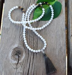 About this Mala: The Gemini Inspired Mala is 8mm genuine moonstone mala beads for June, the astrological sign for Gemini! This artfully designed mala has smoky quartz and goldplated spacers  a quartz crystal guru bead and natural cotton tassel. About Moonstone: Moonstone is composed a milky white Feldspar, it has a slight rainbow essence, and white form of  translucent Labradorite. Limited Edition. Healing Properties: Moonstone speaks of starting fresh, inner development and power. Moonstone hel Cheap White Spiritual Beaded Necklace, Starting Fresh, Personal Success, Astrological Sign, Milky White, Mala Beads, Astrology Signs, Smoky Quartz, Natural Cotton