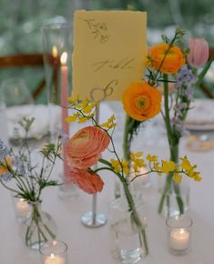 there are many vases with flowers on the table