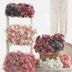 three tiered baskets filled with pink and white flowers