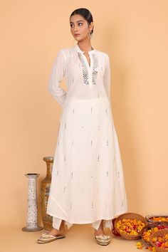 Off white kurta with mukaish embroidery and mandarin collar. Paired with pant.
Components: 2
Neckline: Mandarin Collar
Sleeve Type: Long
Fabric: Cotton
Color: Off White,Silver
Other Details: 
Length:
Kurta: 49 inches
Pant: 40 inches
Note: Dupatta worn by the model is not for sale
Occasion: Puja - Aza Fashions White Mulmul Kurta For Transitional Season, Elegant White Mulmul Kurta, White Sets With Mirror Work For Transitional Season, White Traditional Palazzo Set With Dabka Work, Elegant Cotton Sharara With Mirror Work, White Palazzo Set With Straight Kurta For Transitional Season, Unstitched White Kurta With Gota Work, White Palazzo Set With Dabka Work And Straight Kurta, Designer Off White Kurta With Mirror Work