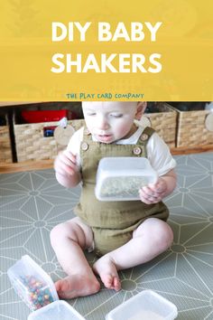 a baby sitting on the floor playing with food