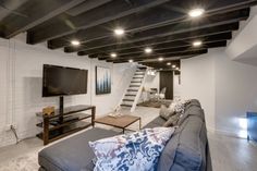 a living room filled with furniture and a flat screen tv