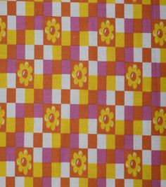 an orange, pink and yellow checkered fabric with flowers on the top is shown