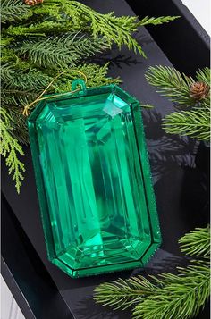 an emerald green stone hanging from a tree