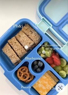 a blue lunch box filled with different types of food and pretzels on top of it