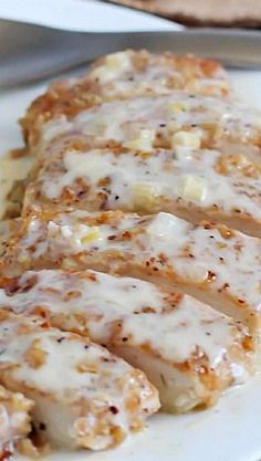 slices of chicken covered in gravy on a white plate