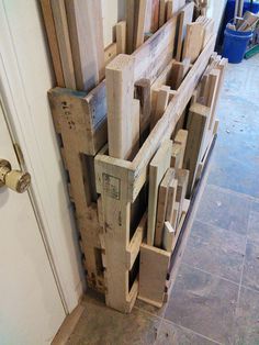 a bunch of wooden pallets stacked on top of each other in front of a door