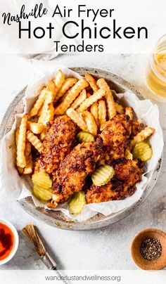 chicken tenders and fries in a bowl with ketchup on the side