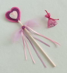 two heart shaped lollipop sticks with pink bows