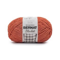 the yarn ball is orange and has a white stripe on it, with black stripes