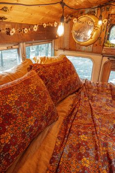 there is a bed with many pillows in the room that looks like it has been made