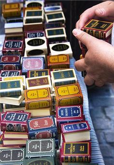 a table topped with lots of books covered in different types of letters and numbers on top of each other