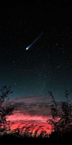 the night sky is filled with stars and bright pink clouds, as well as a shooting star