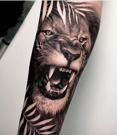 a man's arm with a tiger and zebra tattoo on the left side of his arm