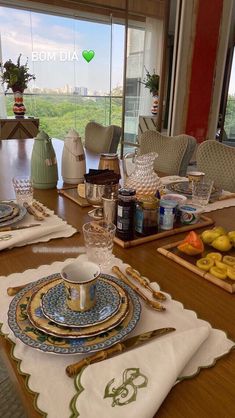 the table is set with dishes and place settings