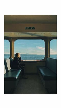 a person sitting on a train looking out the window