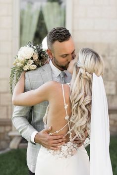 a bride and groom kissing in front of a building with the words, wedding day