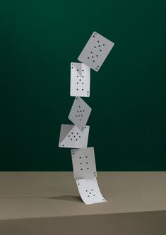 a stack of dominos falling into the air