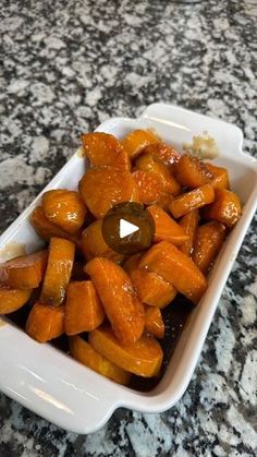 a white dish filled with sliced up carrots