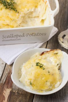 a white bowl filled with mashed potatoes on top of a wooden table next to a casserole dish