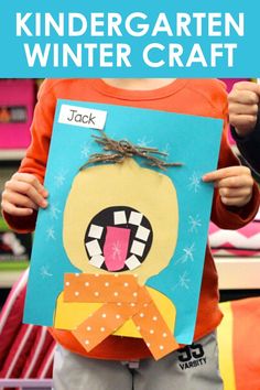 a child holding up a paper cut out of a cartoon character with the words, kindergarten winter craft