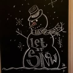 a chalkboard drawing of a snowman with the words let it snow written on it