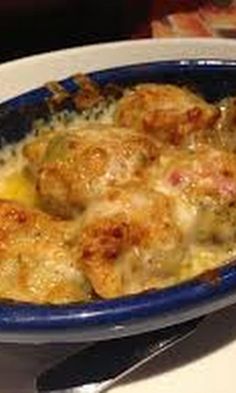 a blue bowl filled with food on top of a table