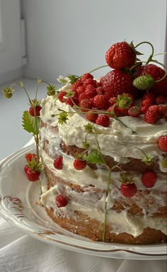 a cake with white frosting and strawberries on top