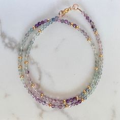 "This beautiful necklace is handcrafted with an array of glittering fluorite gemstones, each unique and rich in natural character.  D E T A I L S » High quality AAA grade fluorite  » Faceted 3mm round beads » 14K gold filled lobster clasp and components  » Length: 17\"  » 100% genuine, natural gemstones » Handmade in NY G I F T I N G  Arrives thoughtfully packaged in an eco-friendly kraft box wrapped with ribbon, ready for gifting or treasuring for yourself. Also includes care instructions and storage bag to keep your item looking beautiful. Please read shop policies for the fine print...thanks for browsing my Etsy shop!" Double Strand Amethyst Gemstone Beads Jewelry, Purple Fluorite Gemstone Beaded Jewelry, Purple Fluorite Gemstone Bead Jewelry, Purple Fluorite Round Bead Jewelry, Fluorite Gemstone Bead Necklace For Gift, Fluorite Gemstone Beads Necklace As Gift, Fluorite Gemstone Beads Necklace For Gifts, Spiritual Fluorite Gemstone Beads Jewelry, Gemstone Choker Necklace