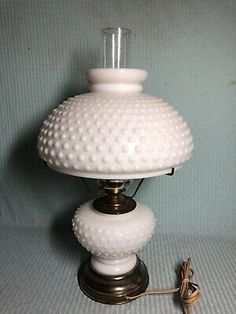 a white lamp sitting on top of a table