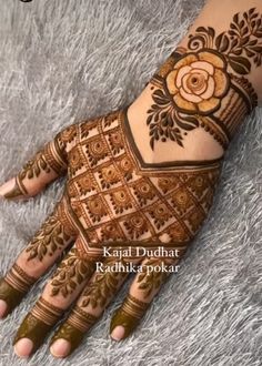 the hand is decorated with henna and flowers