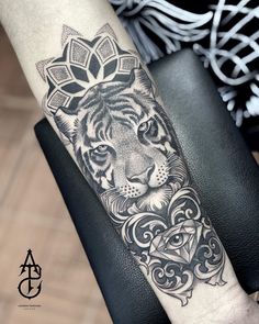 a tiger tattoo on the arm