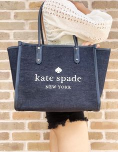 Style: Kate Spade Ella Large White Logo Shoulder Tote Handbag Material: Denim Fabric with Smooth Leather Trim Features: Interior Zip Pocket, 8.5" Double Shoulder Strap Drop, Zip Closure, Protective Bottom Studs, Fabric Lining Measures: 16.8" W x 11.2" H x 6.8" D Katespade Purses, Awesome Kate, Ella Tote, Designer Party Dresses, Bridal Clutch, Fashion Videos, Kate Spade Purse, Large Shoulder Bags, Chanel Deauville Tote Bag