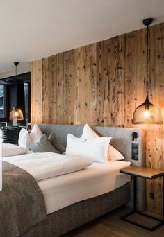 a hotel room with two beds and wooden walls