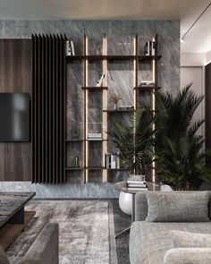 a living room filled with furniture and a flat screen tv mounted on a wall next to a book shelf