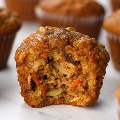 a muffin that has been cut in half and is sitting on a table with other muffins