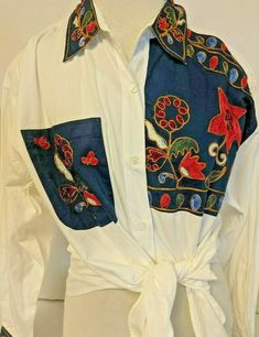 "Vintage 1992 At Last Basics - Button Up Blouse. Blouse is sized Medium, made from 100% cotton with built in shoulder pads. Blouse has long sleeves and button up closure. Primary White in color - blouse has a \"patchwork\" embroidered design. The collar, front pocket, and sleeve cuffs are all embroidered. Shirt is in good lightly pre- owned condition. Approximate Measurements: Bust - 44\" Sleeve - 21 1/2\" Length - 27\"" Womens Blouses, Holiday Essentials, Key To My Heart, Fitz And Floyd, Black Cat Halloween, Button Up Blouse, At Last, Embroidered Blouse, Halloween Cat