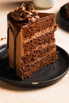 a piece of chocolate cake on a black plate