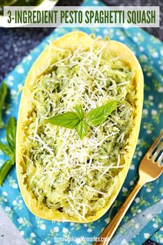 an eggplant pesto spaghetti dish with cheese and herbs in it on a blue cloth