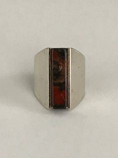 This ring unites quiet strength with sophisticated simplicity. A rectangular agate column, just short of 1" in length and 1/4" wide, makes up the center of this eye catching ring. It's held in by the silver frame which starts out the same length as the stone and tapers off in the back and turns into a comfortable band. It is signed inside the band. The Henning Ulrichsen jewelry company was established in Denmark in 1951 and is still in existence and being run by the second generation. This ring Gold Snake, Charm Rings, Agate Ring, Jewelry Companies, Silver Frame, Amethyst Ring, Ring Box, Rings Statement, Art Deco Fashion