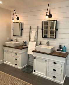 two sinks and mirrors in a bathroom with wood counter tops on either side of them