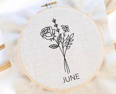 a cross - stitch pattern with the words june and three roses in black on it