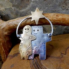 A Fanciful Artisan Star Children Pin made by Susan Roggio. Her Whimsical style is on full display in this playful pin. It features 2 children. One child is Sterling Silver the other is Brass.  A Brass Star shines overhead.  A Little Magic For You! Size:  Width: 1.3 inches (35mm)  Height: 1.95 inches (50mm) Weight: 6 grams Marked: Roggio Sterling Good vintage condition. Some light scratches. Pin back clasp works perfectly. Your purchase will arrive in a gift box with tag and raffia tie, all tucke