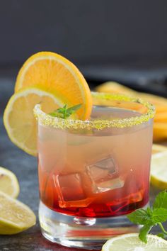 a close up of a drink with lemons and mint